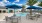 a pool with tables and chairs next to it
