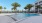 a pool with palm trees and buildings