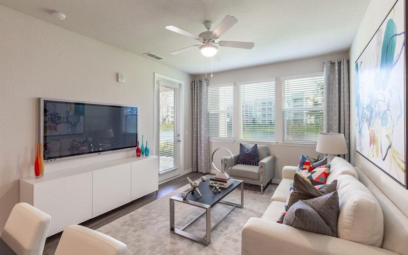 a living room with a tv and couches